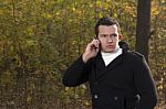 Man Talking On The Phone In The Park Stock Photo