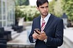 Man Using A Smart Phone On The Street Stock Photo