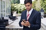 Man Using A Smart Phone On The Street Stock Photo