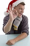 Man Wearing Santa Hat With Gesture Stock Photo