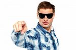 Man Wearing Sunglasses And Pointing Stock Photo