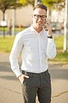 Man With Glasses Speak On Mobile Phone In Hands Stock Photo