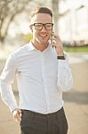 Man With Glasses Speak On Mobile Phone In Hands Stock Photo