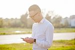 Man With Glasses Speak On Mobile Phone In Hands Stock Photo