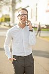 Man With Glasses Speak On Mobile Phone In Hands Stock Photo