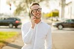 Man With Glasses Speak On Mobile Phone In Hands Stock Photo