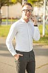 Man With Glasses Speak On Mobile Phone In Hands Stock Photo