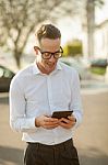 Man With Glasses Speak On Mobile Phone In Hands Stock Photo