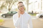 Man With Glasses Speak On Mobile Phone In Hands Stock Photo