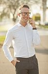 Man With Glasses Speak On Mobile Phone In Hands Stock Photo