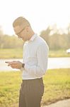 Man With Glasses Texting On Mobile Phone In Hands Stock Photo