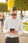 Man With Mobile Phone In Hands Stock Photo