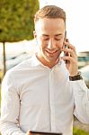 Man With Mobile Phone In Hands Stock Photo