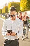 Man With Mobile Phone In Hands Stock Photo