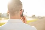 Man With Mobile Phone In Hands, Back View, Outdoor Stock Photo