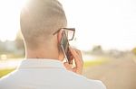 Man With Mobile Phone In Hands, Back View, Outdoor Stock Photo