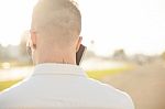 Man With Mobile Phone In Hands, Back View, Outdoor Stock Photo