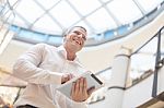 Man With Tablet Computer In Modern Business Building Stock Photo