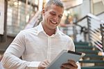 Man With Tablet Computer In Modern Business Building Stock Photo