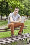 Man With Tablet Computer In Park Stock Photo