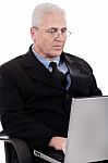 Mature Business Man Busy Working In Notebook Stock Photo