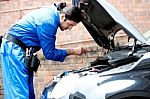 Mechanic Tightening The Screw, Inside Car Stock Photo