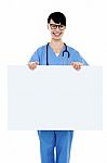 Medical Practitioner Holding Blank Ad Board Stock Photo