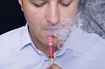 Men Smoke An Electronic Cigarette Stock Photo