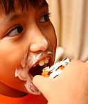 Messy Face Child Eating Cake Stock Photo