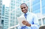 Middle Aged Businessman Using A Tablet Stock Photo