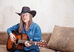 Middle-aged Man In A Hat Plays Guitar And Sings Stock Photo