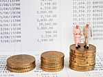 Miniature Senior Couple Stand On Pile Of Euro Coins. Retirement Stock Photo