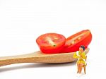 Miniature Woman Sitting On Fresh Grape Or Cherry Tomato With Woo Stock Photo