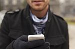 Mobile Phone In Hands With Glowes, Cold Weather Stock Photo