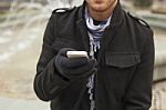 Mobile Phone In Hands With Glowes, Cold Weather Stock Photo