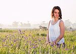 Model Sitting In Field Stock Photo