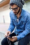 Modern Young Man With Mobile Phone In The Street Stock Photo