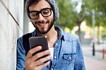 Modern Young Man With Mobile Phone In The Street Stock Photo