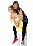 Mom And Daughter Enjoying Piggyback Stock Photo