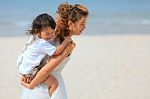 Mom And Son Play On Beach Stock Photo