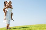 mom Giving Piggyback Ride Stock Photo