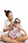 Mom Is Holding And Playing With Her Baby On White Background Stock Photo