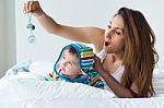 Mother And Baby Playing And Smiling At Home Stock Photo