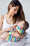 Mother And Baby Playing And Smiling At Home Stock Photo