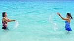 Mother And Daughter Happy On The Beach Stock Photo