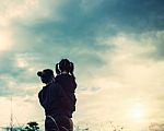 Mother And Daughter On Sunset Watching On Sky Stock Photo