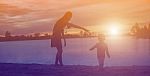 Mother And Daughter On Sunset Watching On Sky Stock Photo