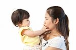 Mother And Her Baby In Action On White Background Stock Photo