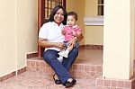 Mother And Son Outside Of Their New House.  Focus On The Baby Stock Photo