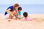 Mother And Sons Are Playing On Tropical Beach Stock Photo